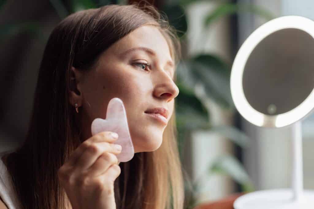 young-caucasian-woman-doing-gua-sha-face-massage-f-2023-11-27-05-17-29-utc