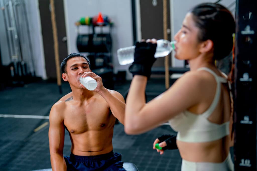 asian-sport-man-and-woman-drink-water-from-bottle-2023-11-27-05-36-00-utc asian-sport-man-and-woman-drink-water-from-bottle-2023-11-27-05-36-00-utc
