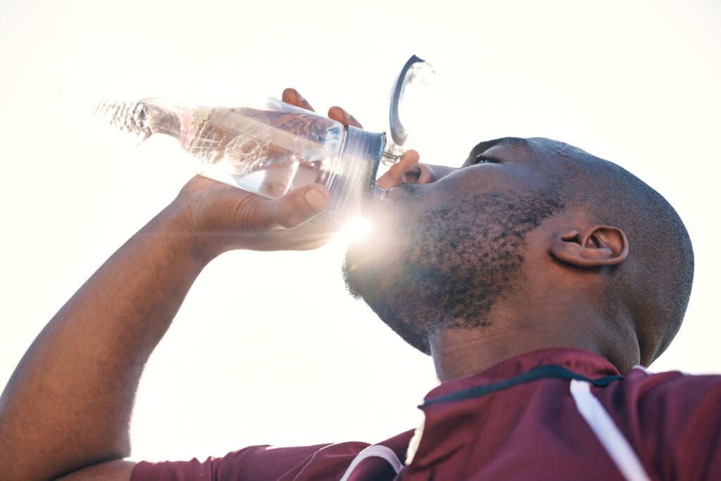 black-man-drinking-water-and-health-with-fitness-2023-11-27-05-05-56-utc