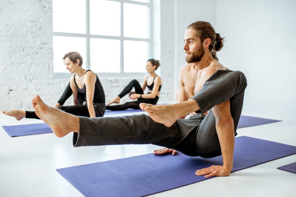 Group of people practising yoga indoors