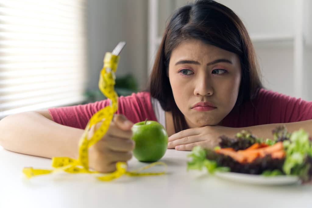 asian-young-girl-feeling-bore-to-have-diet-food-su-2023-11-27-04-51-58-utc
