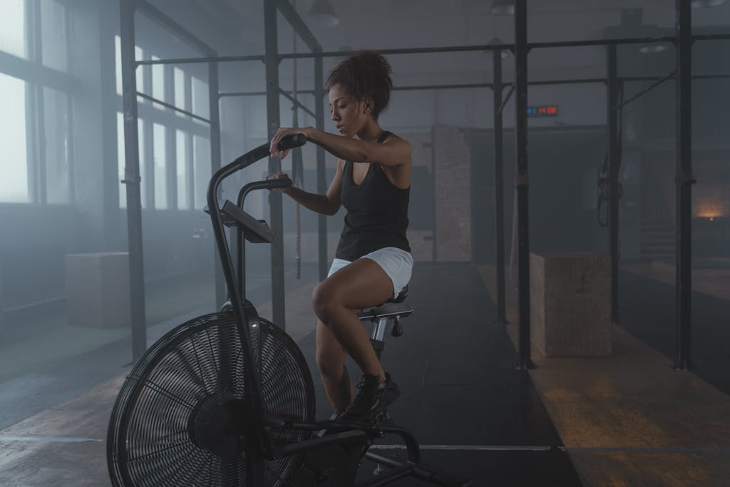 Tabata Ride: A High-Intensity Workout for Maximum Results A Woman in Black Tank Top Sitting on an Air Bike