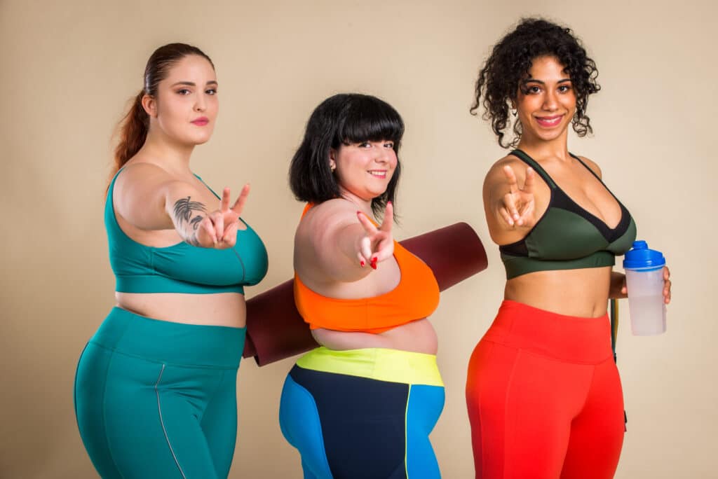 Plus size women posing for body acceptance