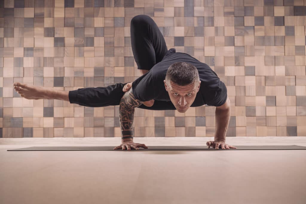Adult man performs asana exercises. Yoga concept. Sports and hea