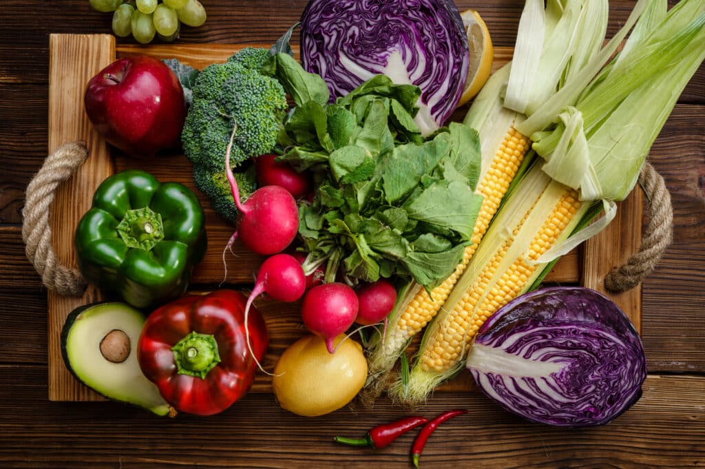 Vegetable set on wooden board closeup, top view