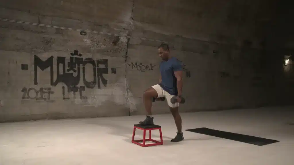 Step-Up-With-Dumbbells-0-29-screenshot black man lifting weights with stool