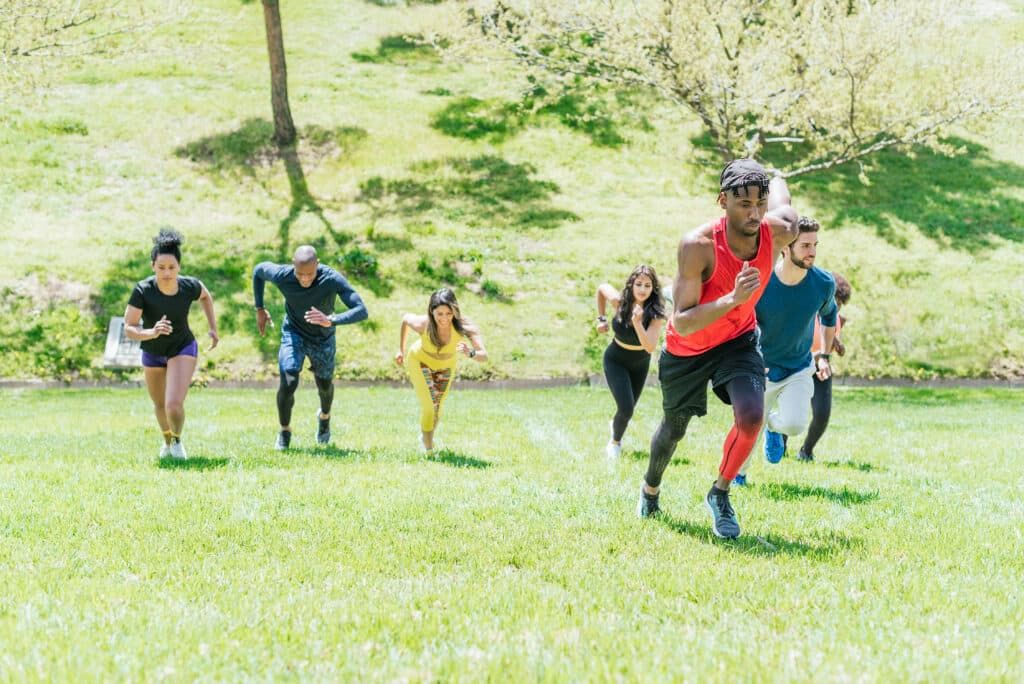 Group of runners running up a hill.