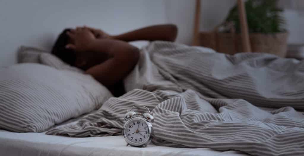 Sleepless, woman suffering from insomnia, sleep apnea or stress, headache or migraine