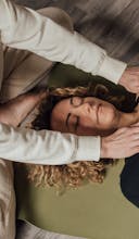 Woman in White Long Sleeve Shirt Lying on Bed
