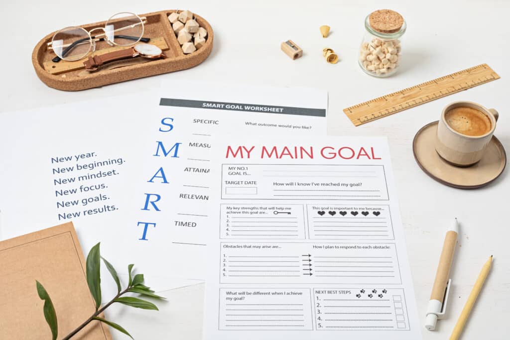 Desktop with goal setting template and office accessories