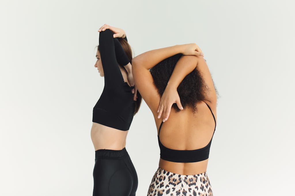 What to Wear to Pilates: A Complete Guide Women Stretching Their Shoulders
