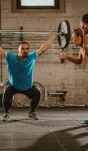 a man lifting weights with a woman lifting weights