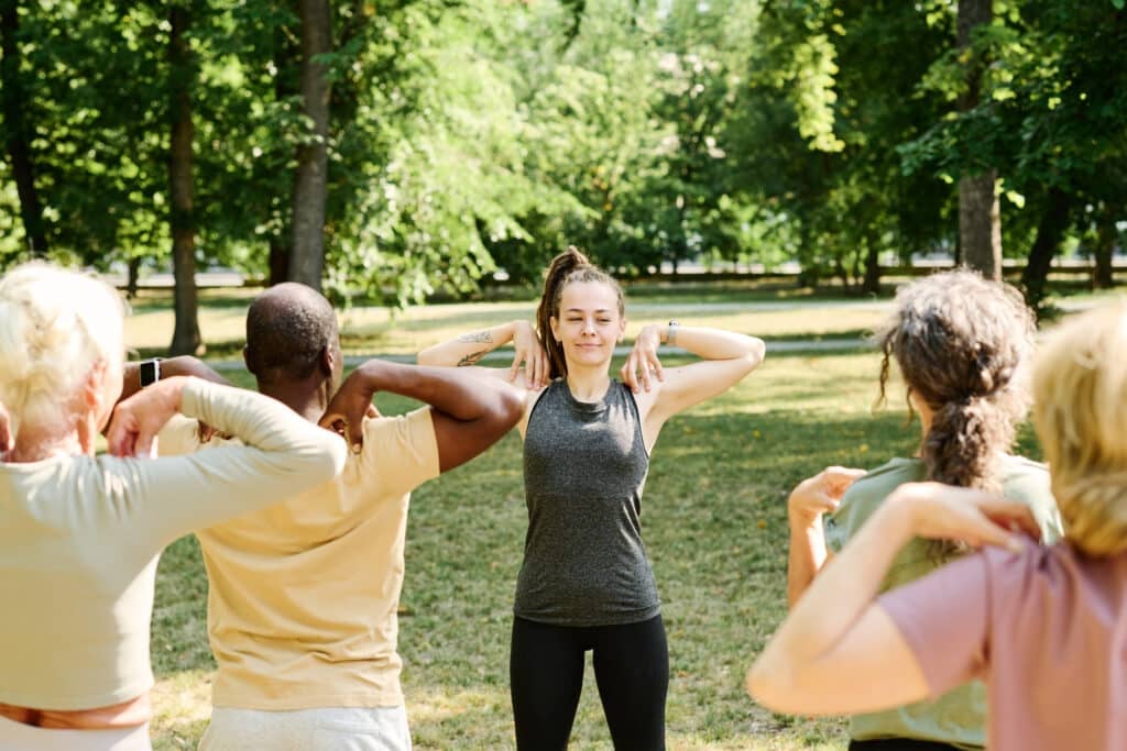 Young woman training senior people outdoors