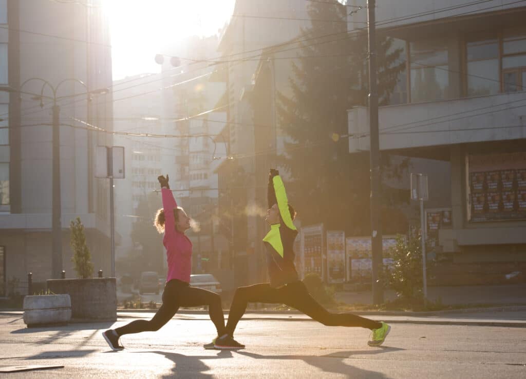 couple warming up before jogging