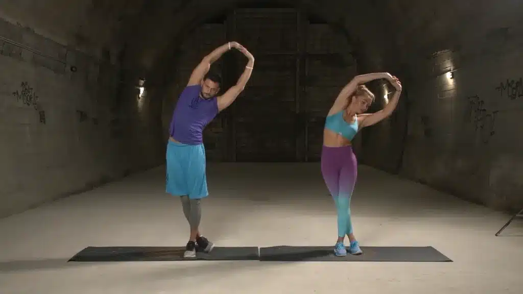 Standing-It-Band-Stretch-Ext-0-8-screenshot man and woman stretching upper body