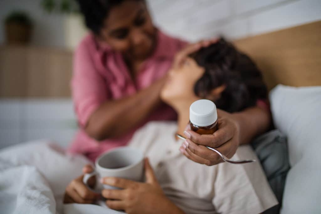 Mother taking care of her sick son at home.