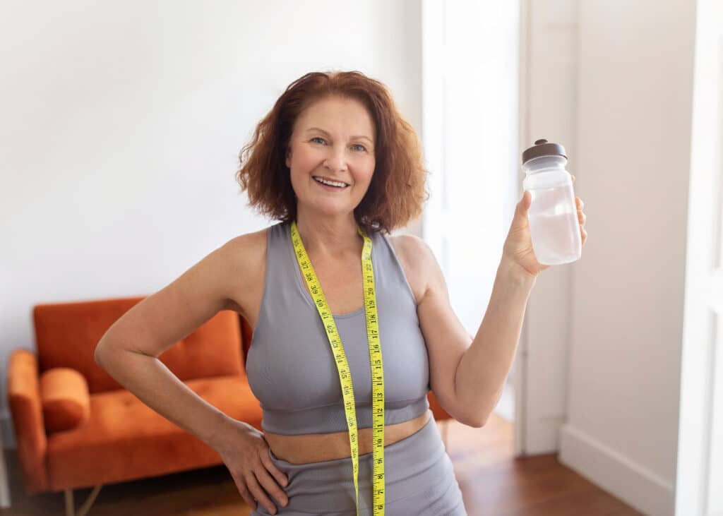 a woman holding a bottle of water