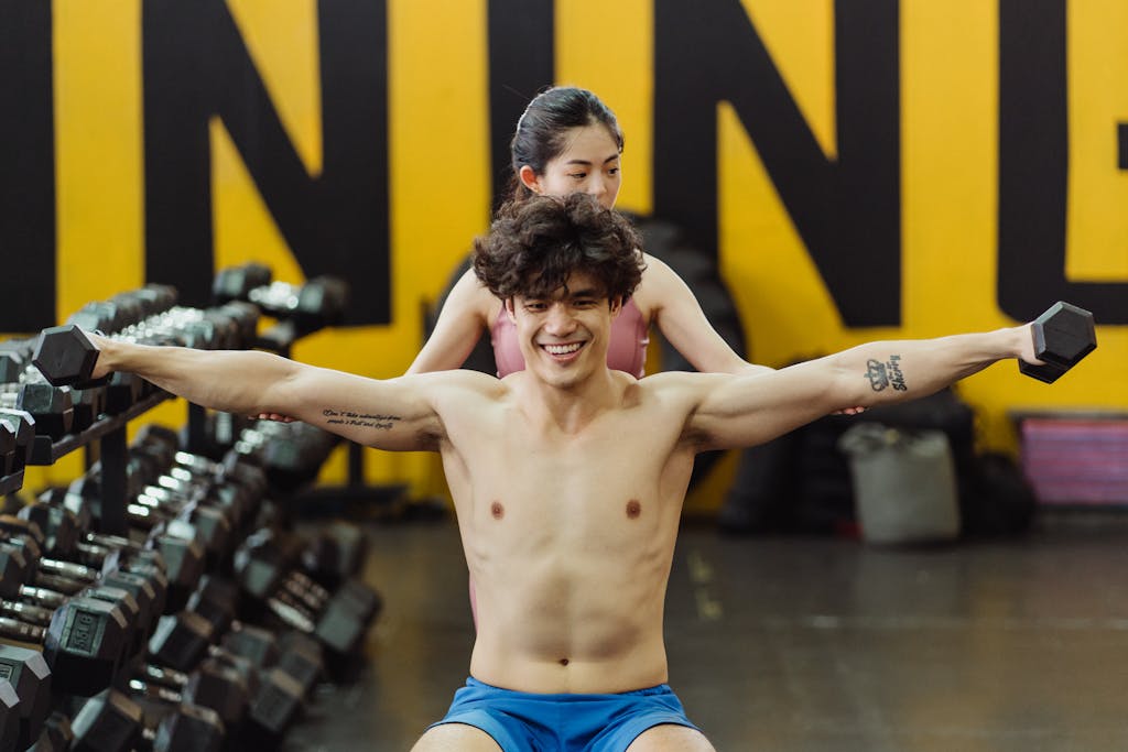 Photo by Ketut Subiyanto A Man Working out at a Gym