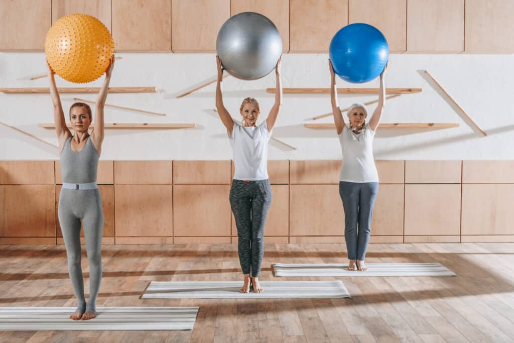 group of senior people exercising with fitness balls in studio group of senior people exercising with fitness balls in studio