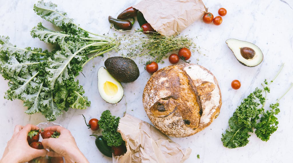 Photo by Elle Hughes Flat-lay Photograph of Bread, Tomatoes, and Avocados