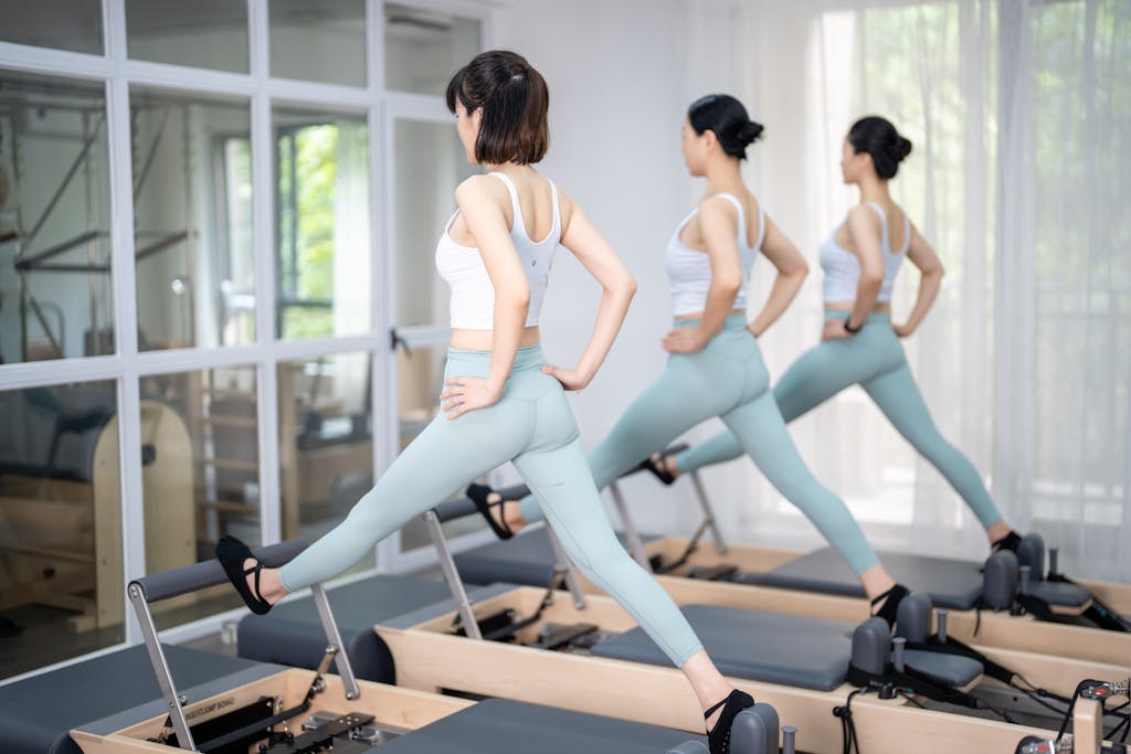 How Much Are Pilates Classes: A Comprehensive Pricing Guide Three women stretching at gym