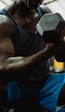 Supersets Explained: Maximize Your Workouts for Explosive Results Man Lifting Dumbbell