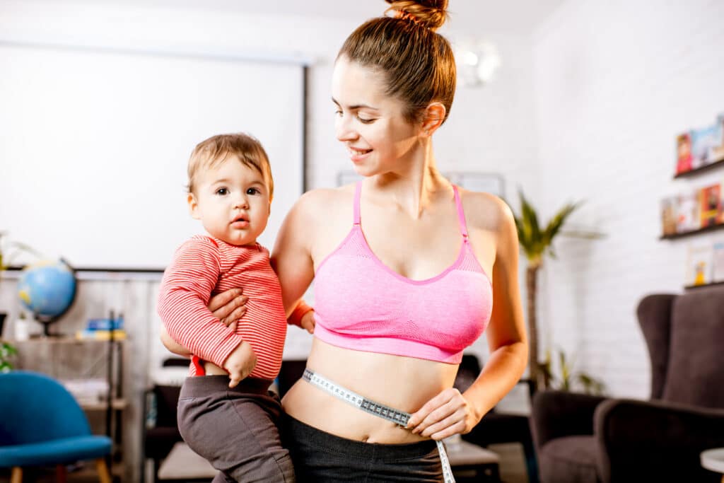 Mother measuring her waist