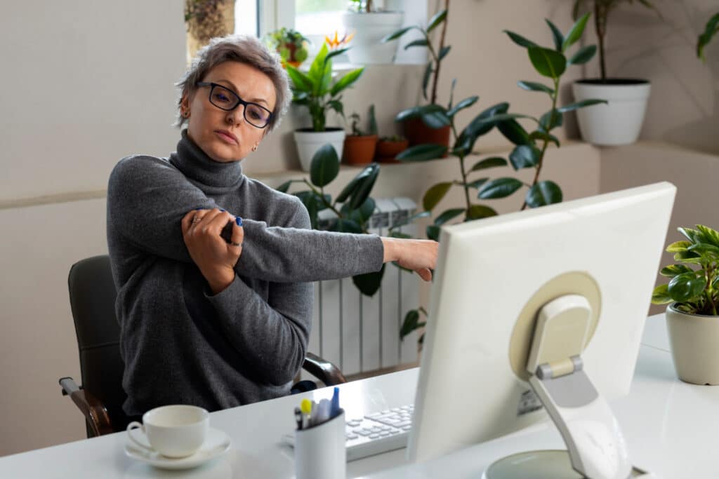 Workplace wellness stretch at desk - Zen2Fit Corporate Wellness