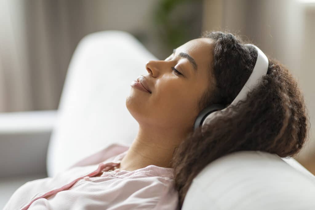 Serene African American woman resting on couch