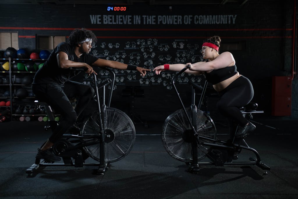 Tabata Ride: A High-Intensity Workout for Maximum Results Man and Woman Exercising Using a Stationary Bicycle