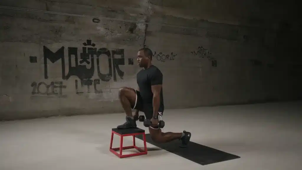 Front-Foot-Elevated-Split-Squat-With-Dumbbells-Bottom-Pause-0-39-screenshot black man lifting weights