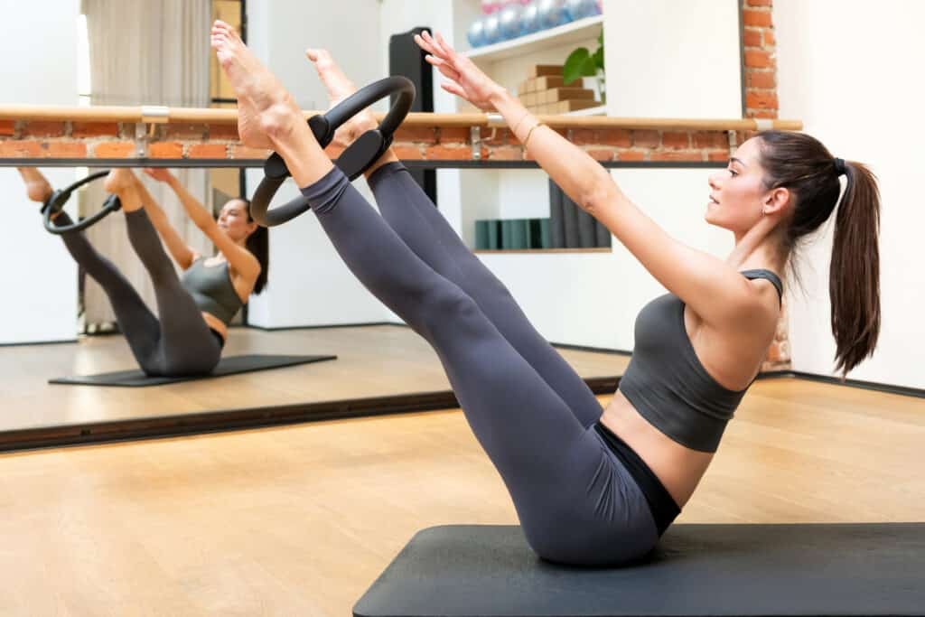 Young woman working out with a Pilates magic circle Young woman working out with a Pilates magic circle
