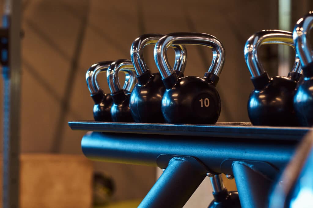 Closeup image of dumbells on a stand. Gym equipment kettlebells for strength training