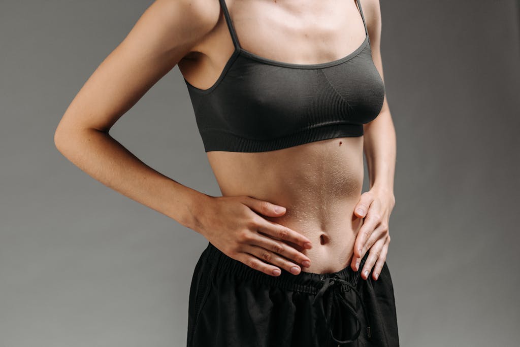Woman in Black Sports Bra and Black Skirt