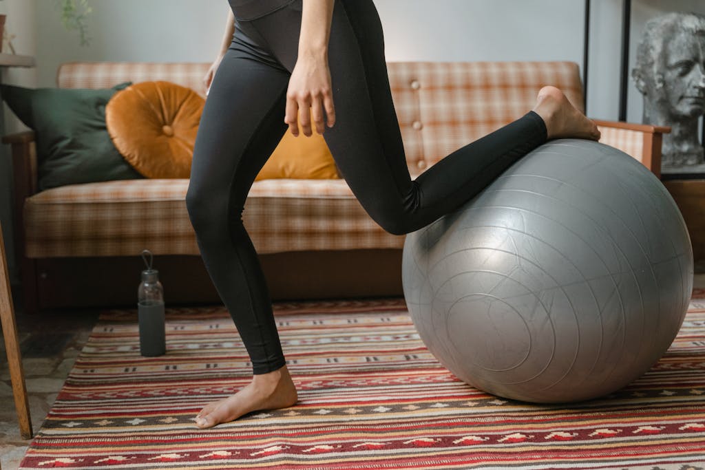 How Much Are Pilates Classes: A Comprehensive Pricing Guide Person Using an Exercise Ball