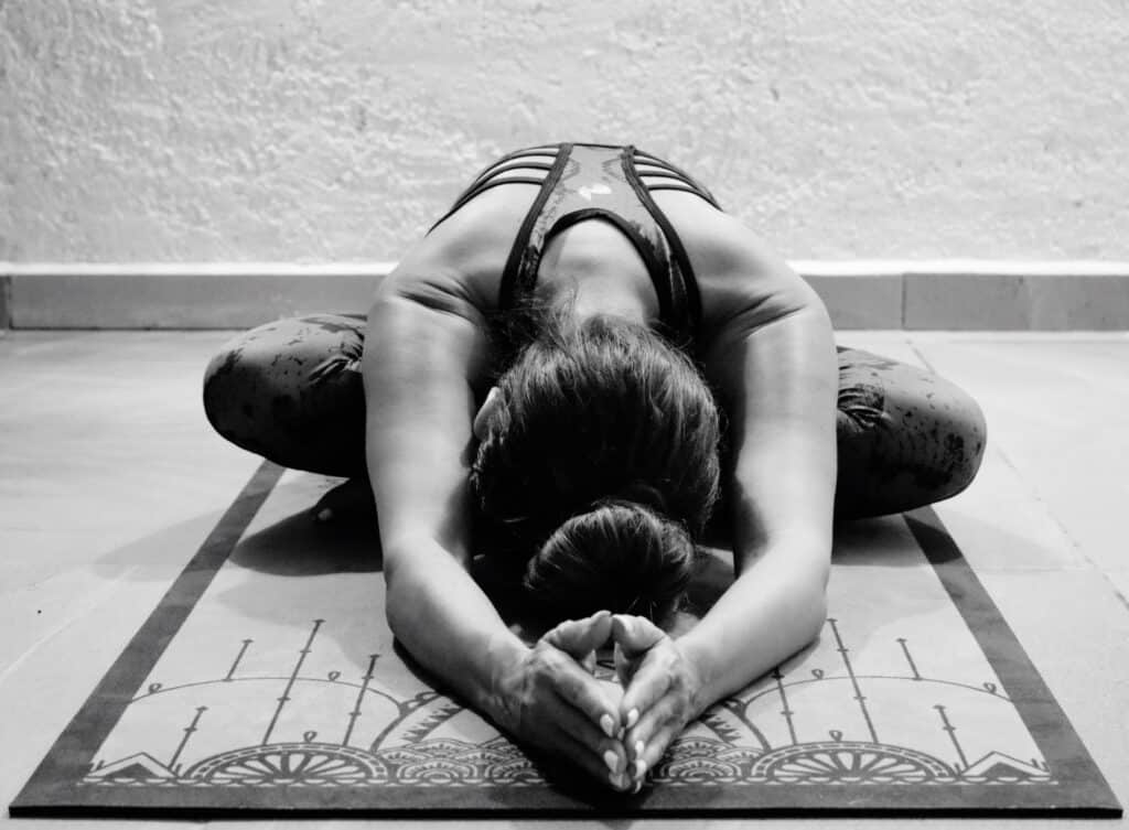woman-practicing-yoga-mat-against-wall-home woman-practicing-yoga-mat-against-wall-home