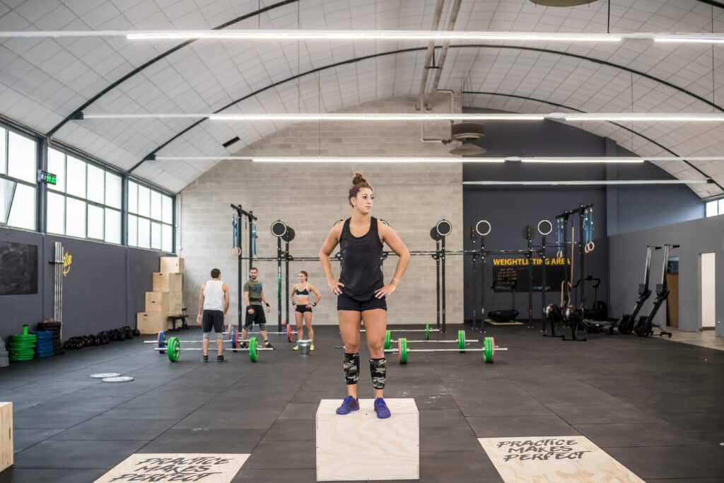 Young fit sportive woman posing indoor gym taking a break from t Young fit sportive woman posing indoor gym taking a break from t
