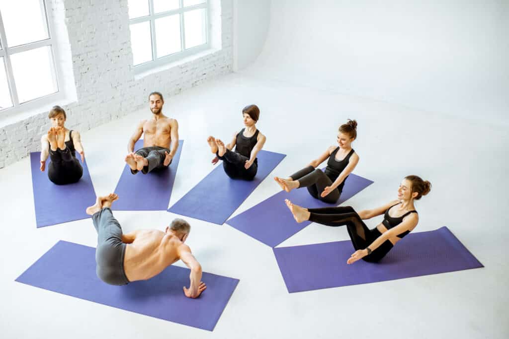 Group of people practising yoga indoors