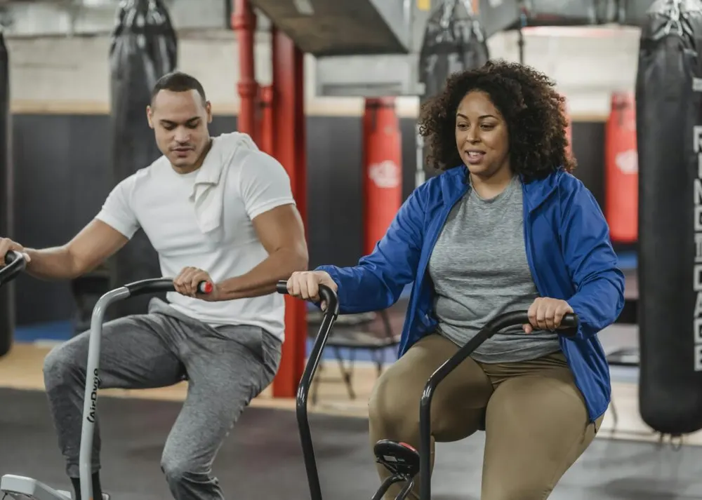 Coach supporting a member during a workout